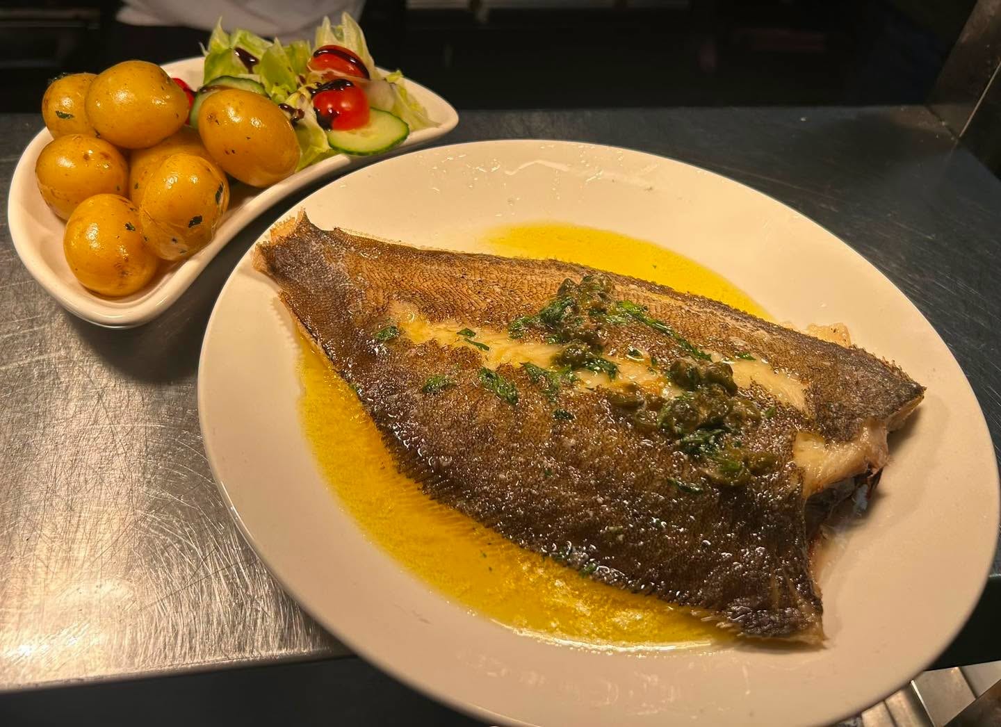 Grilled whole fish with salad and potatoes served at The Whitehall in Llandovery
