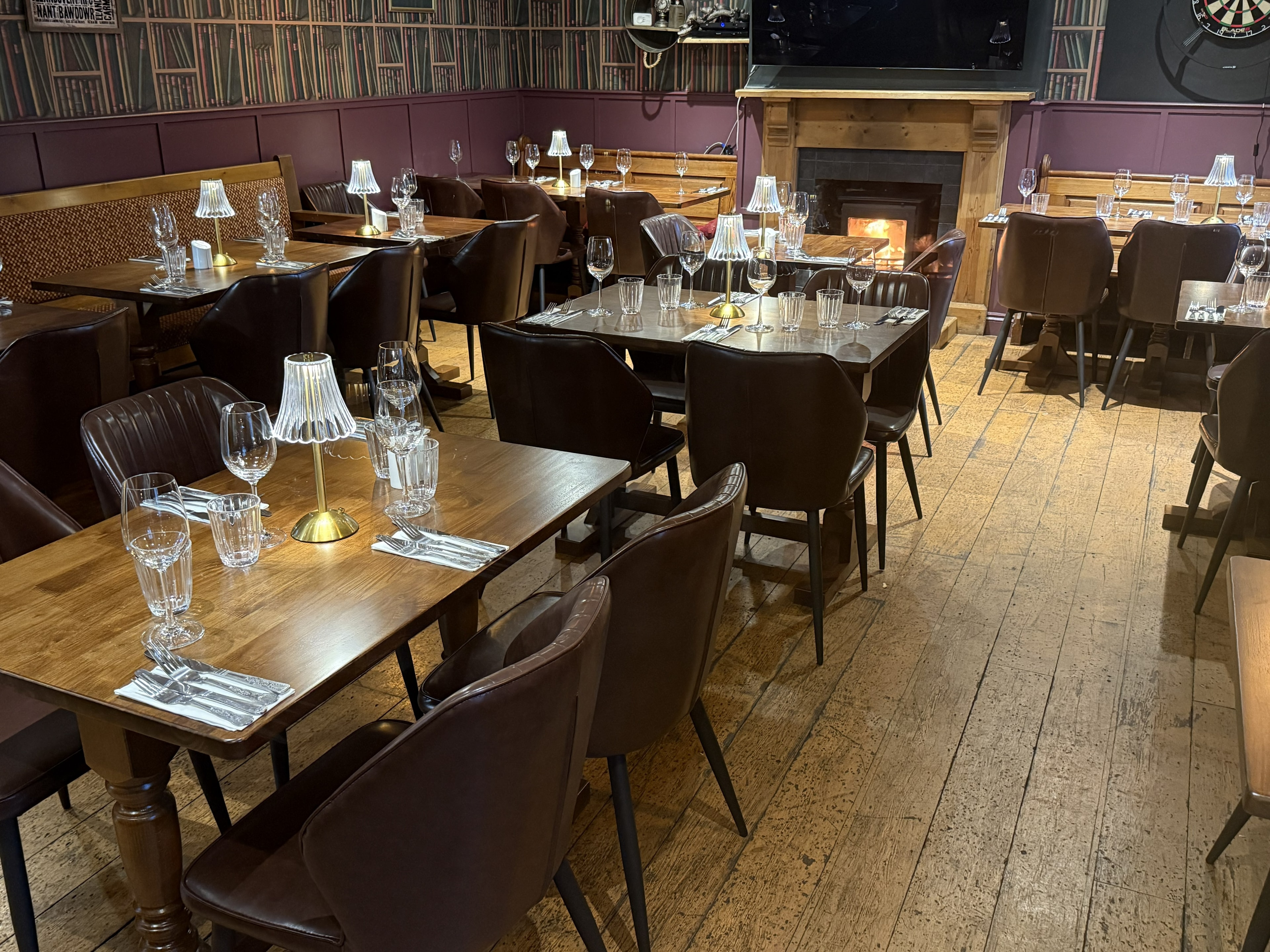 Cosy interior of The Whitehall with stone fireplace